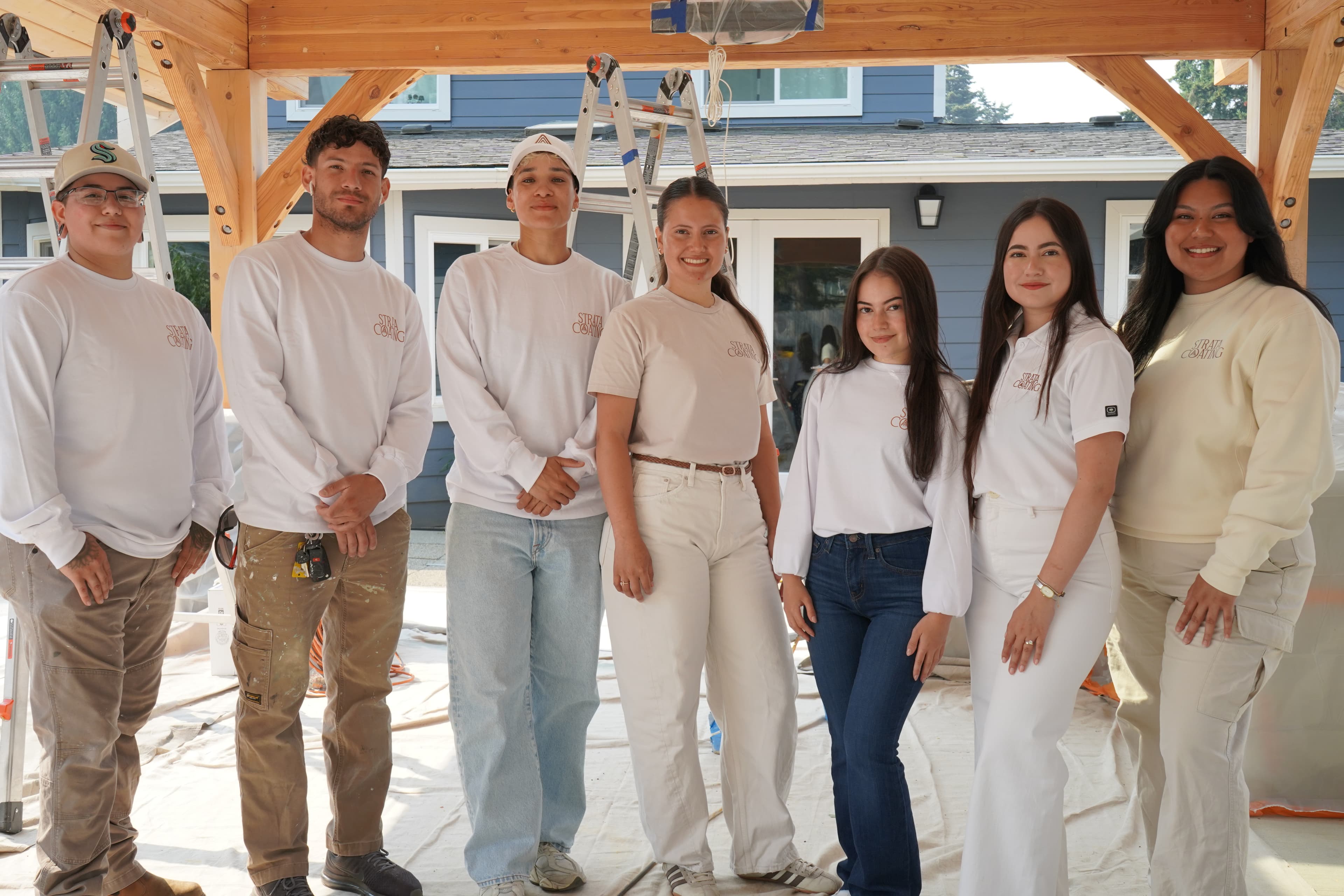 Strata Coating team members in front of a freshly painted craftsman home