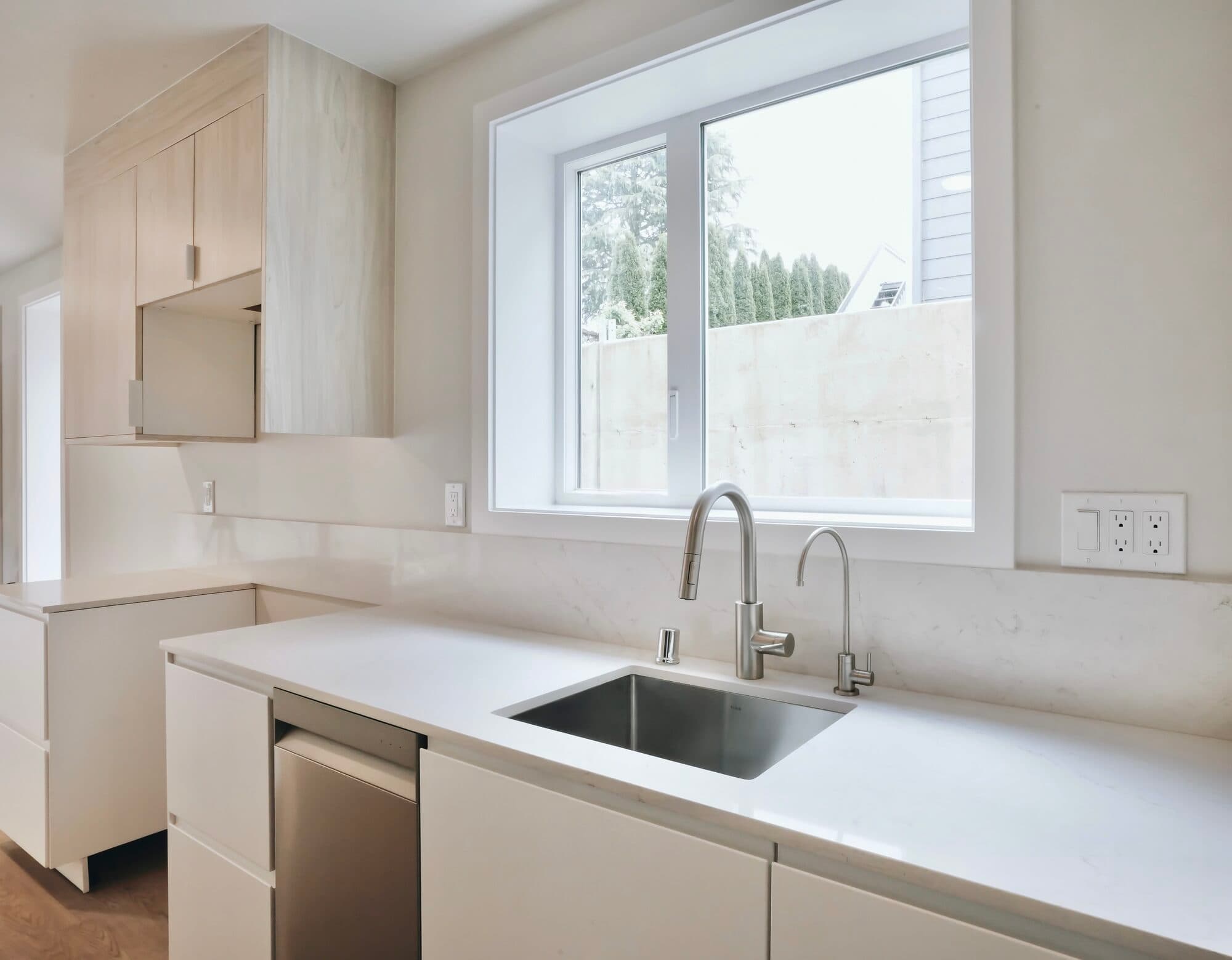 A finished bright white kitchen with flawless cabinetry and millwork by Strata Coating